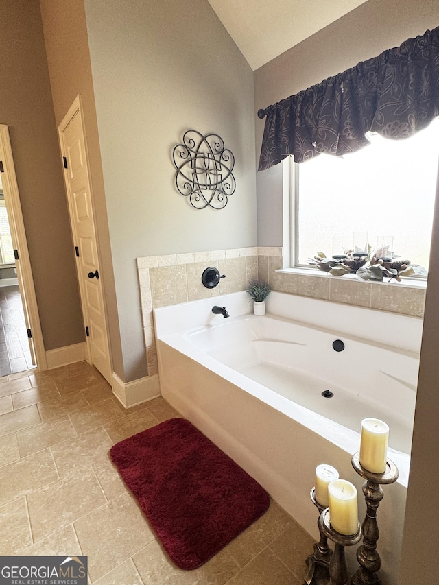1869 Schofield Dr, Hampton, GA 30228 - full bathroom featuring a garden tub and lofted ceiling