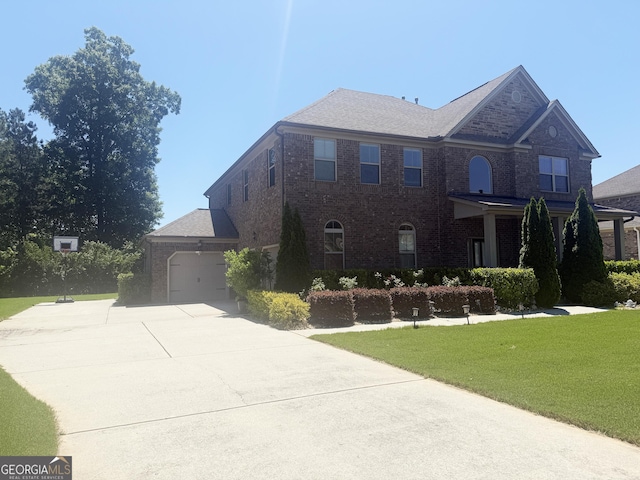 1869 Schofield Dr, Hampton, GA 30228 - view of front of home with concrete driveway, brick siding, a front yard, and a garage