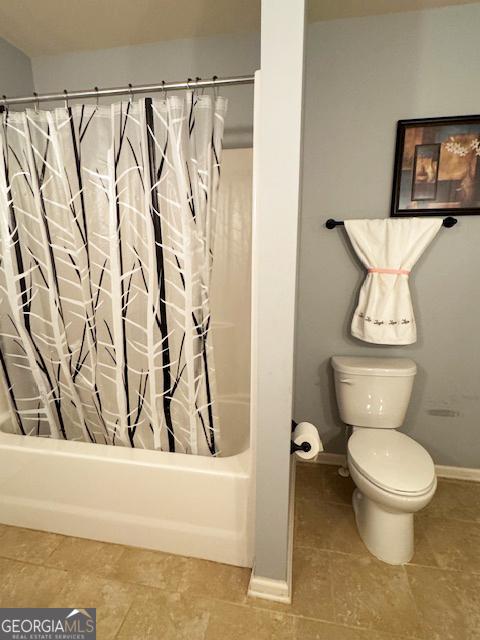 1869 Schofield Dr, Hampton, GA 30228 - bathroom with toilet and shower / tub combo with curtain