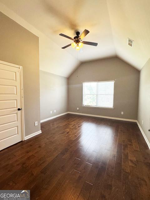 1869 Schofield Dr, Hampton, GA 30228 - additional living space featuring dark wood finished floors, ceiling fan, and lofted ceiling
