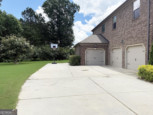1869 Schofield Dr, Hampton, GA 30228 - view of side of home with brick siding, driveway, a lawn, and an attached garage