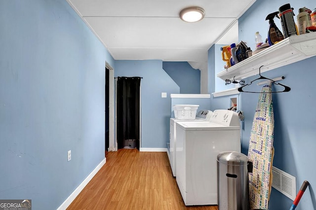4110 Belvedere Dr, Gainesville, GA 30506 - washroom with washing machine and clothes dryer, light wood finished floors, and baseboards