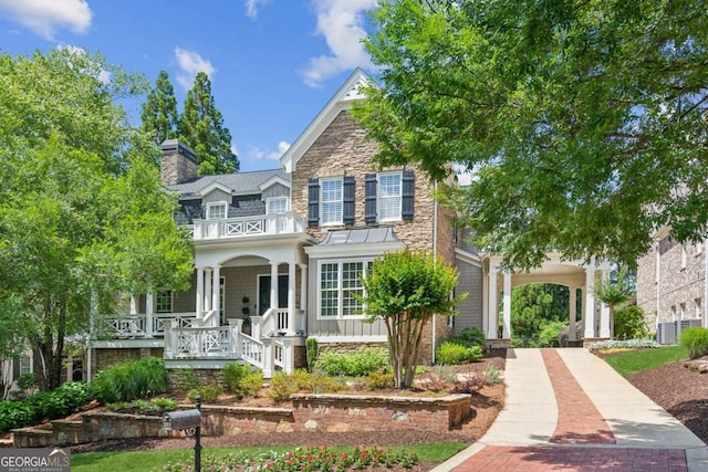 3903 Hazelhurst Dr, Marietta, GA 30066 - view of front of property with a porch, a balcony, a chimney, stone siding, and decorative driveway