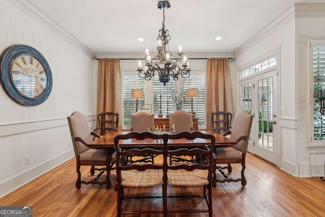 3903 Hazelhurst Dr, Marietta, GA 30066 - dining room featuring ornamental molding, a chandelier, a decorative wall, light wood-style flooring, and wainscoting