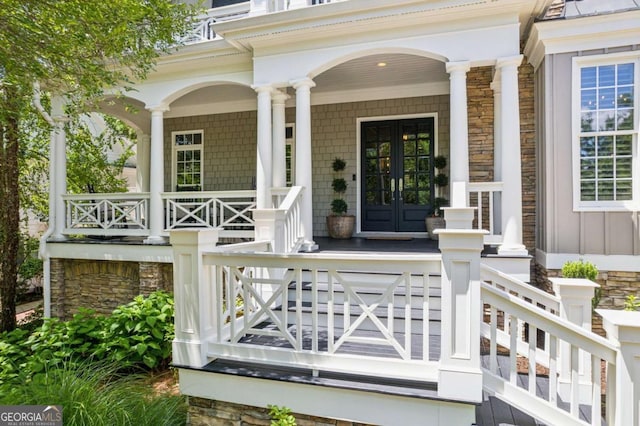 3903 Hazelhurst Dr, Marietta, GA 30066 - doorway to property with covered porch, stone siding, and french doors