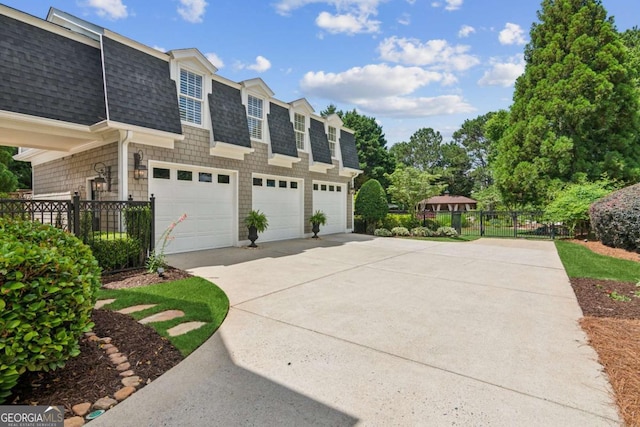 3903 Hazelhurst Dr, Marietta, GA 30066 - view of side of home with a shingled roof, concrete driveway, a garage, and mansard roof