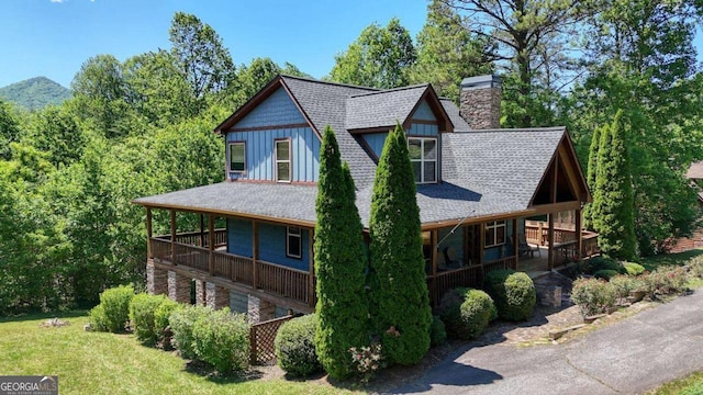 602 Mill Ridge Rd, Hiawassee, GA 30546 - view of front facade with a shingled roof, a chimney, a porch, and board and batten siding