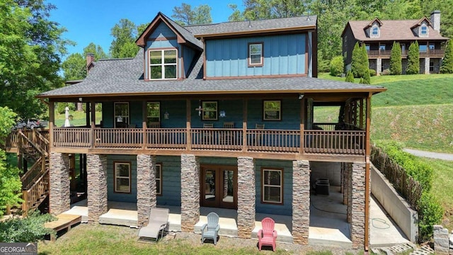 602 Mill Ridge Rd, Hiawassee, GA 30546 - rear view of property featuring board and batten siding, a patio area, a yard, a chimney, and a shingled roof