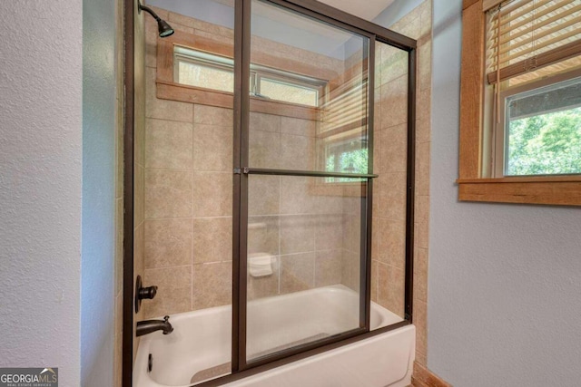 602 Mill Ridge Rd, Hiawassee, GA 30546 - bathroom with a textured wall and combined bath / shower with glass door