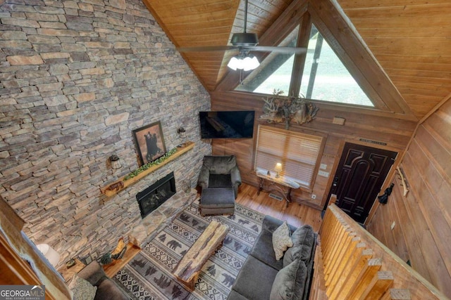 602 Mill Ridge Rd, Hiawassee, GA 30546 - living room with wooden ceiling, wood finished floors, wood walls, lofted ceiling, and a fireplace