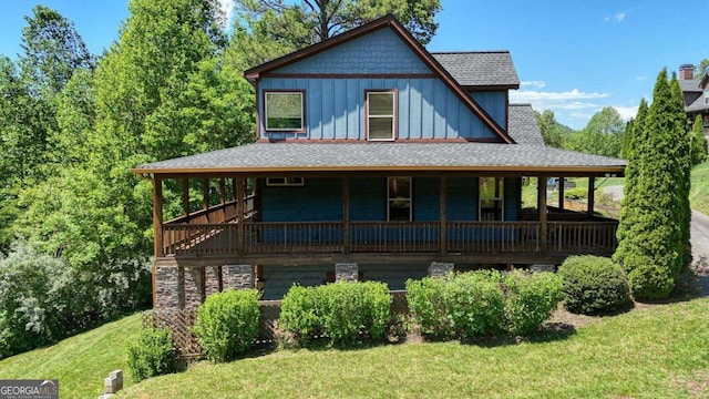 602 Mill Ridge Rd, Hiawassee, GA 30546 - country-style home with board and batten siding, a front lawn, a shingled roof, and covered porch