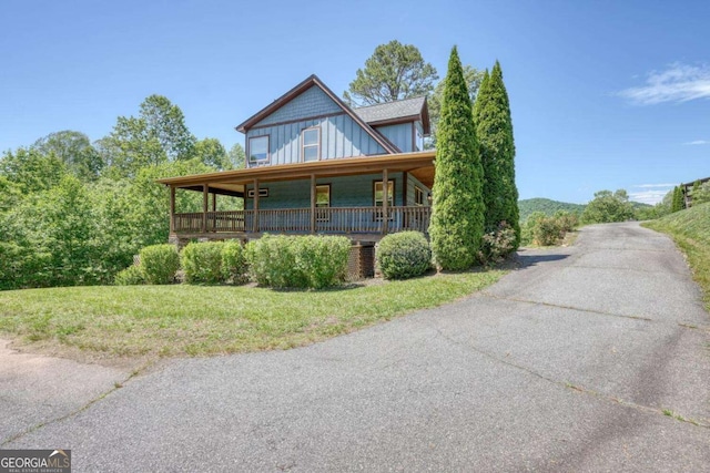 602 Mill Ridge Rd, Hiawassee, GA 30546 - view of front of home featuring board and batten siding, a porch, and a front lawn