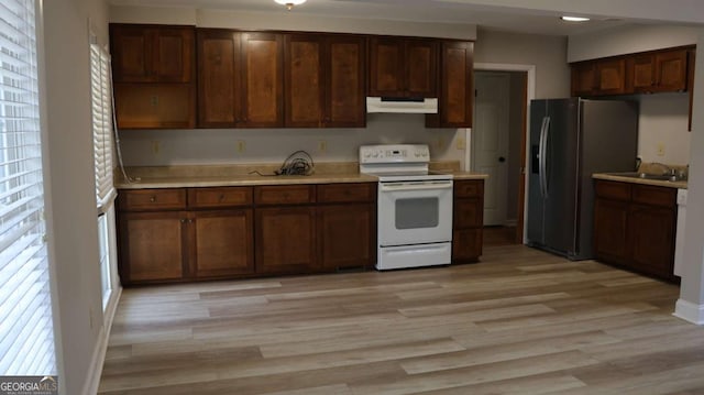 114 Sycamore Rd SW, Milledgeville, GA 31061 - kitchen featuring white range with electric cooktop, refrigerator with ice dispenser, under cabinet range hood, and light countertops