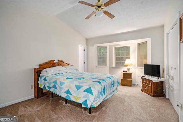 7847 Dogwood Way, Douglasville, GA 30134 - bedroom with light carpet, lofted ceiling, baseboards, a textured ceiling, and ceiling fan
