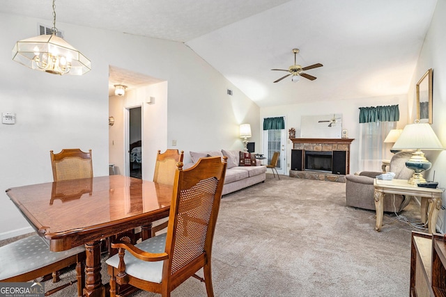 7847 Dogwood Way, Douglasville, GA 30134 - carpeted dining space with lofted ceiling, ceiling fan, a fireplace with raised hearth, and a chandelier