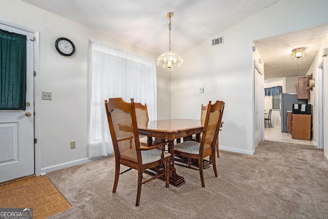 7847 Dogwood Way, Douglasville, GA 30134 - dining room with a chandelier, baseboards, vaulted ceiling, and light colored carpet