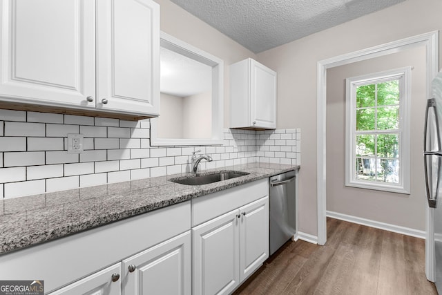 80 Corn Row Ct, Newnan, GA 30263 - kitchen featuring stainless steel appliances, dark wood-style flooring, white cabinets, decorative backsplash, and a sink