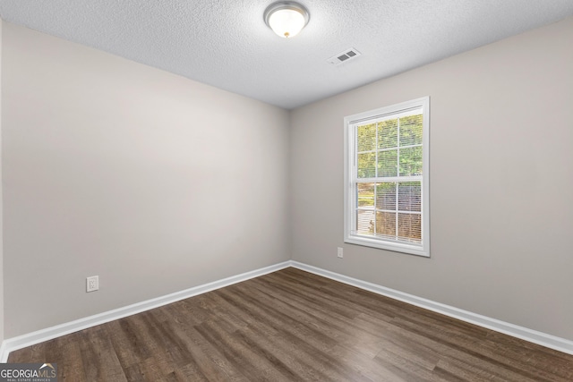 80 Corn Row Ct, Newnan, GA 30263 - spare room with dark wood-type flooring, a textured ceiling, and baseboards