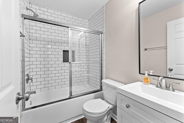 80 Corn Row Ct, Newnan, GA 30263 - full bathroom with a textured ceiling, vanity, combined bath / shower with glass door, and toilet