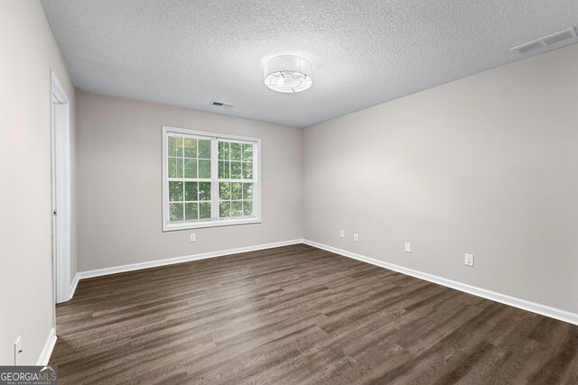 80 Corn Row Ct, Newnan, GA 30263 - spare room with dark wood-type flooring, baseboards, and a textured ceiling