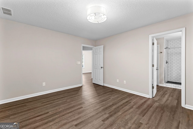 80 Corn Row Ct, Newnan, GA 30263 - unfurnished bedroom with dark wood-type flooring, a textured ceiling, and baseboards