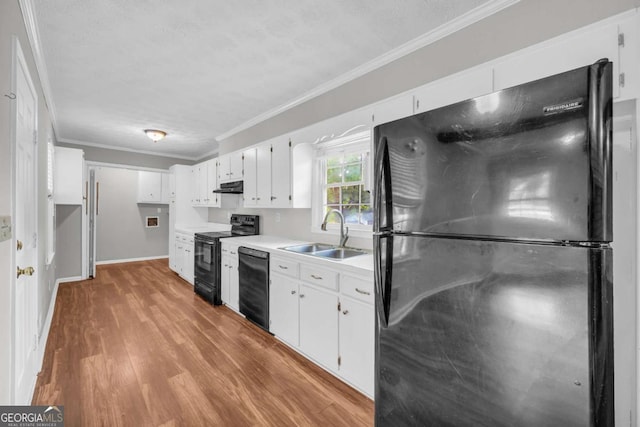 3642 S Bogan Rd, Buford, GA 30519 - kitchen featuring black appliances, a sink, crown molding, under cabinet range hood, and light wood-style flooring