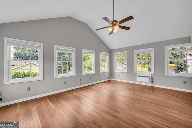 3642 S Bogan Rd, Buford, GA 30519 - unfurnished room featuring a ceiling fan, a wall unit AC, light wood-type flooring, baseboards, and high vaulted ceiling