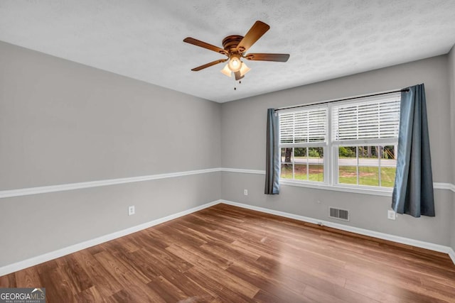 3642 S Bogan Rd, Buford, GA 30519 - spare room with wood finished floors, baseboards, and a ceiling fan