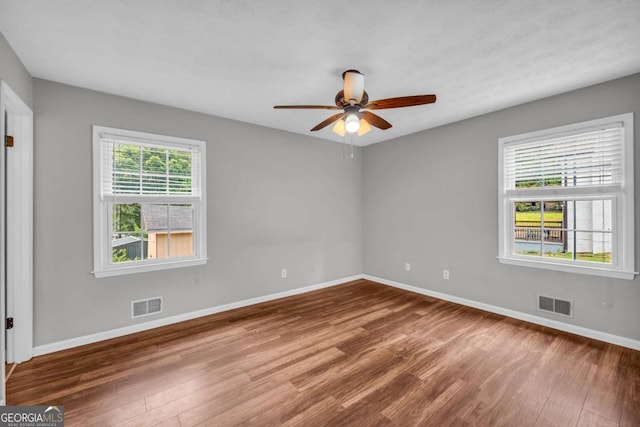 3642 S Bogan Rd, Buford, GA 30519 - empty room with wood finished floors, baseboards, and a ceiling fan