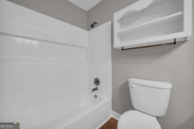 3642 S Bogan Rd, Buford, GA 30519 - bathroom with toilet, shower / bathtub combination, wood finished floors, and baseboards
