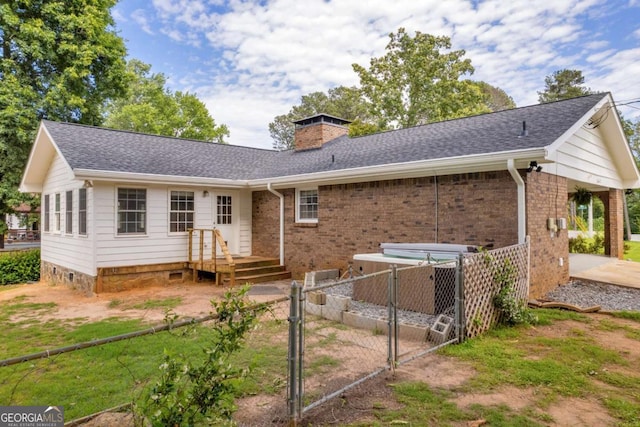 3642 S Bogan Rd, Buford, GA 30519 - rear view of house with a gate, a chimney, roof with shingles, and brick siding