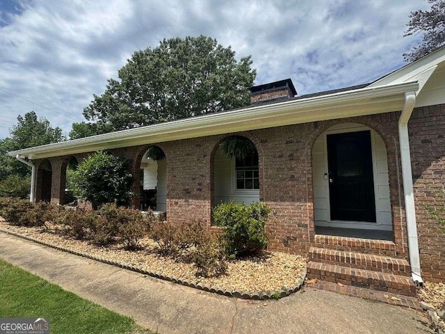 3642 S Bogan Rd, Buford, GA 30519 - view of front of home featuring brick siding, entry steps, and a chimney