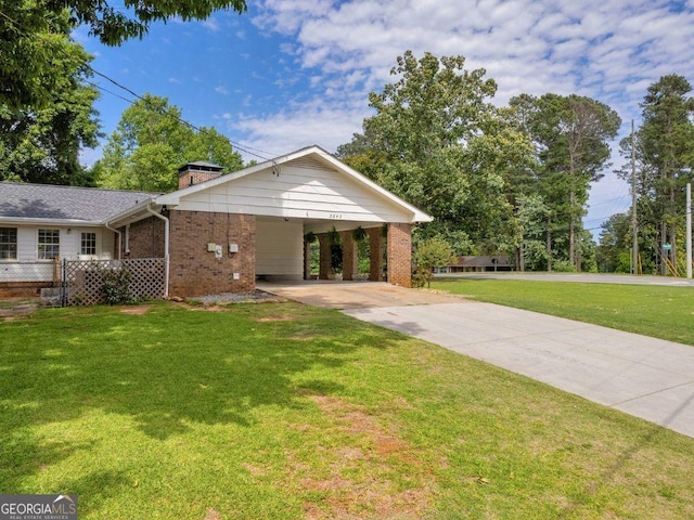 3642 S Bogan Rd, Buford, GA 30519 - view of front of house featuring brick siding, a chimney, concrete driveway, and an attached carport