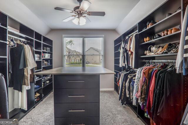 4818 Moon Hollow Ct, Buford, GA 30519 - spacious closet with ceiling fan, carpet floors, and vaulted ceiling