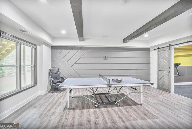 4818 Moon Hollow Ct, Buford, GA 30519 - rec room featuring a barn door, beam ceiling, wood finished floors, baseboards, and recessed lighting