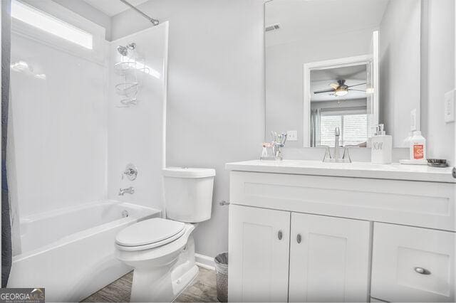 4818 Moon Hollow Ct, Buford, GA 30519 - full bathroom with vanity, shower / bath combo, toilet, ceiling fan, and baseboards
