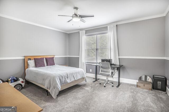 4818 Moon Hollow Ct, Buford, GA 30519 - carpeted bedroom featuring ornamental molding, baseboards, an office area, and ceiling fan