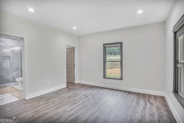 4818 Moon Hollow Ct, Buford, GA 30519 - unfurnished bedroom with wood finished floors, baseboards, recessed lighting, and connected bathroom