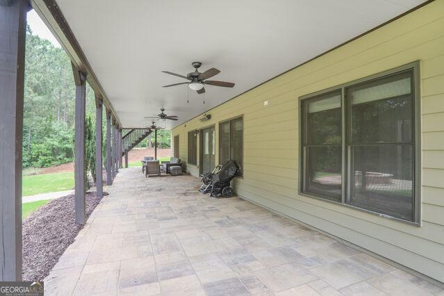 4818 Moon Hollow Ct, Buford, GA 30519 - view of patio with ceiling fan and stairs