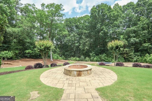 4818 Moon Hollow Ct, Buford, GA 30519 - view of grassy yard with a fire pit and a patio