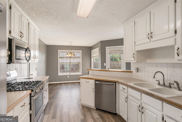 1478 Elena Dr, Mcdonough, GA 30253 - kitchen featuring stainless steel appliances, white cabinets, dark wood-style floors, light countertops, and a textured ceiling