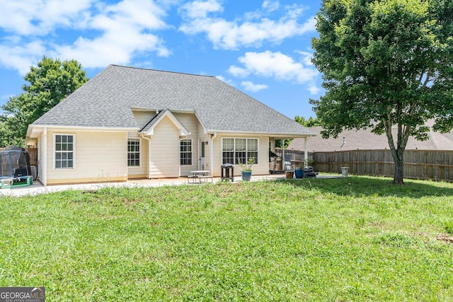1478 Elena Dr, Mcdonough, GA 30253 - back of house with a patio area, a shingled roof, and a trampoline