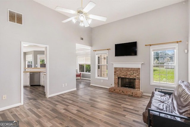 1478 Elena Dr, Mcdonough, GA 30253 - unfurnished living room with high vaulted ceiling, wood finished floors, ceiling fan, and a fireplace
