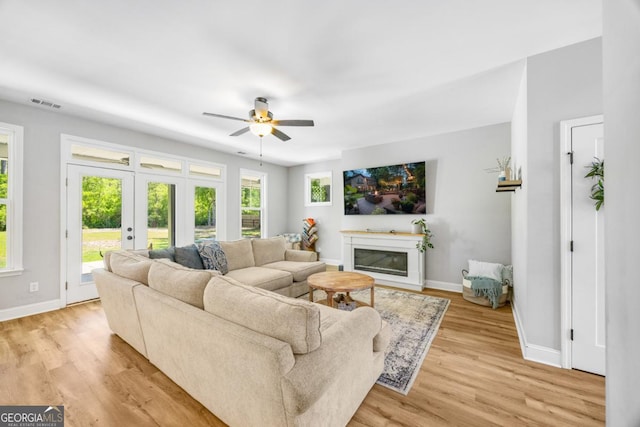 204 Dean Dr, Guyton, GA 31312 - living area with ceiling fan, baseboards, light wood finished floors, and a glass covered fireplace