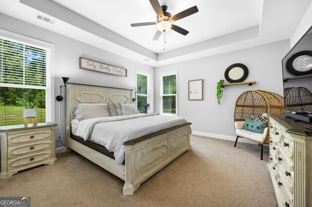 204 Dean Dr, Guyton, GA 31312 - bedroom featuring light colored carpet, baseboards, a tray ceiling, and ceiling fan