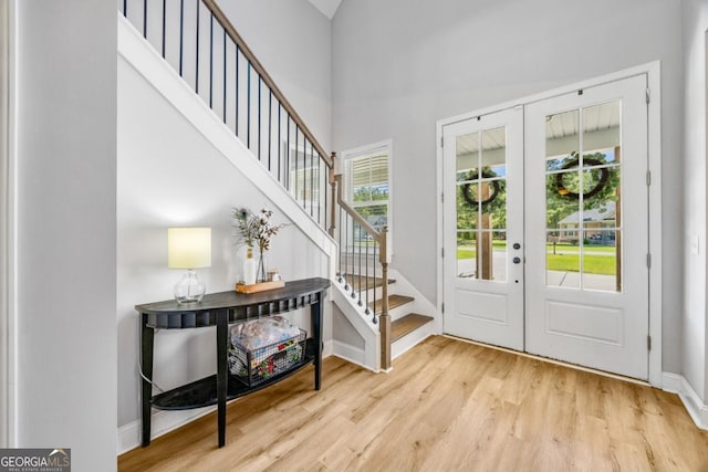 204 Dean Dr, Guyton, GA 31312 - entrance foyer featuring french doors, wood finished floors, stairway, baseboards, and a towering ceiling
