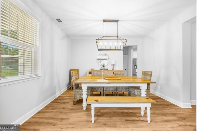 204 Dean Dr, Guyton, GA 31312 - dining room featuring a chandelier, light wood-type flooring, and baseboards