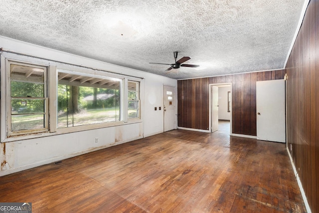 117 Chester Harris Dr, Dallas, GA 30132 - entryway with wood finished floors, ceiling fan, wooden walls, and a textured ceiling