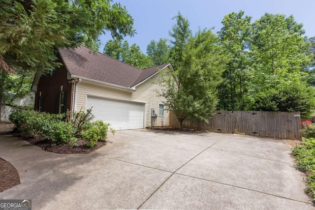5533 Rose Ridge Ct, Flowery Branch, GA 30542 - view of property exterior with driveway, an attached garage, and a shingled roof