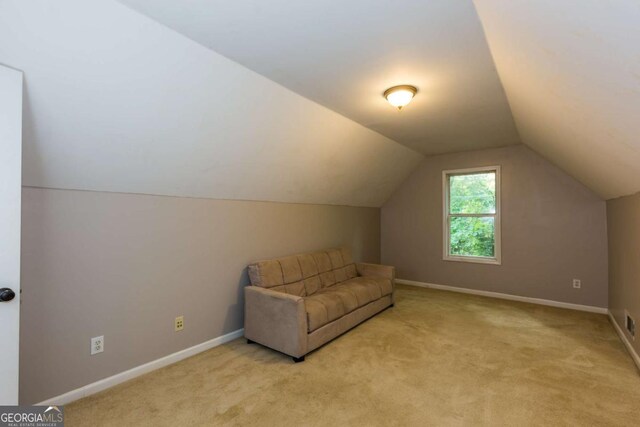 5533 Rose Ridge Ct, Flowery Branch, GA 30542 - living area with light carpet, vaulted ceiling, and baseboards